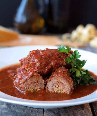 Braciole, braised flank steak cooked in a tomato wine sauce.