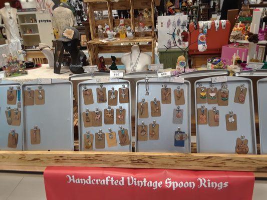 Displayed charms attached to metal trays by magnet.