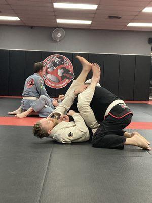 Drilling Arm bars  in BJJ class to warm up