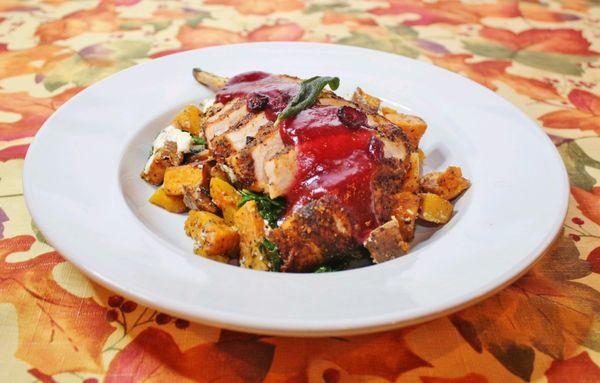 Pork Chop over Autumn Hash with Cranberry Apple Gastrique.