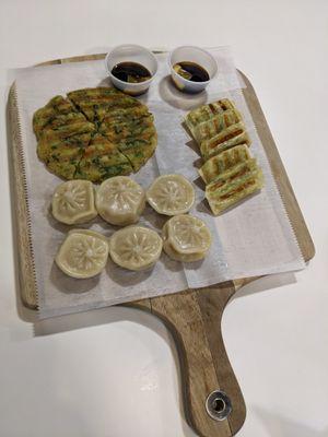 Orders of steamed dumplings, grilled dumplings, and scallion pancake