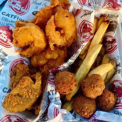 Fries cod, shrimp, hush puppies, fried green tomatoes, and french fries.