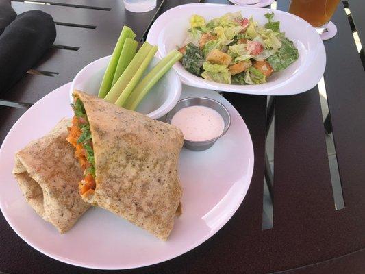 Buffalo chicken wrap with celery and Cesar salad.