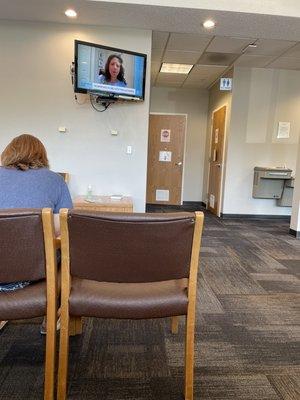 Lobby has a water fountain, tv with sound, and two single stall bathrooms.