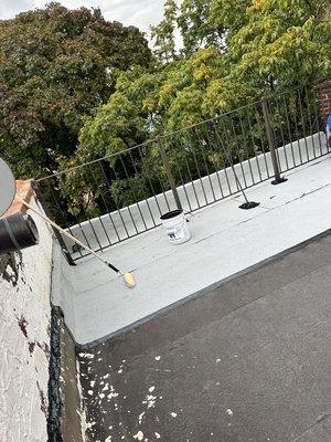 New Firestone white granulated being installed to back gutter