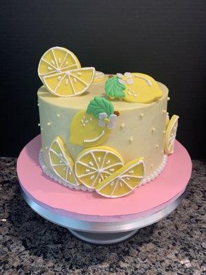 Lemon velvet cake with buttercream frosting and handmade sugar paste decorations