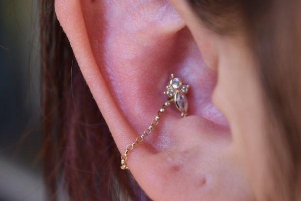 14k yellow gold conch piercing with conch chain