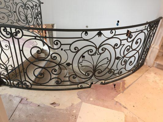 Installing our curved railing with beautiful scrolls and metal flower details