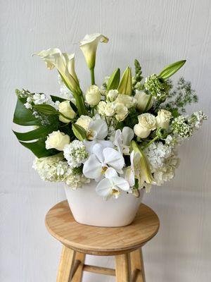 All White and Green flowers in a oval ceramic vase