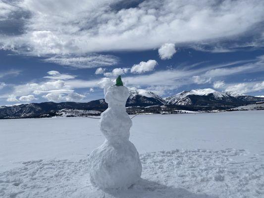 Snowman on frozen lake