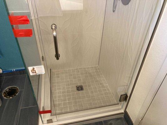 Bottom of glass with clips and shower door handle (inside and outside)