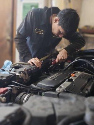 Expert technician inspecting engine components for optimal performance and identifying potential issues at Ernie's Auto Service