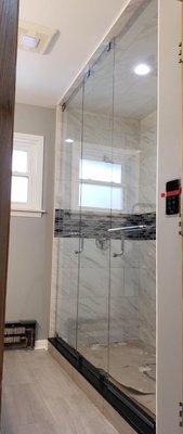 Steam shower with frameless glass