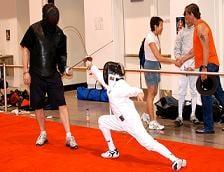 Daniel Hondor, head coach at Olympia Fencing Center, preparing a young fencer for competition.