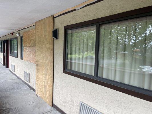 Room next door is boarded over, ceiling of walkway under repair