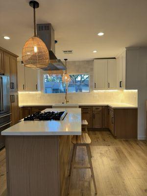 Here is the vision coming to life  with new cabinets, Island , stove hood , beautiful lighting