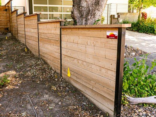 Here's a recently built horizontal stepped fence  with a top cap fascia and steel post option!