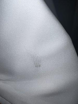 Marks and spots throughout the dress