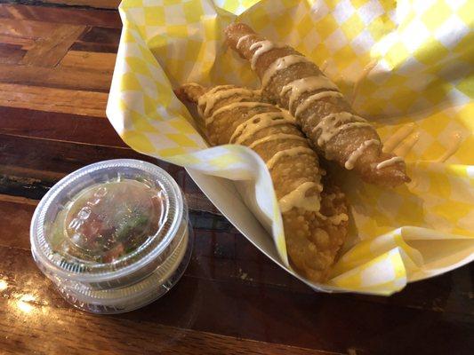 Empanadas (1 beef 1 spinach and cheese) with cheese drizzle finish