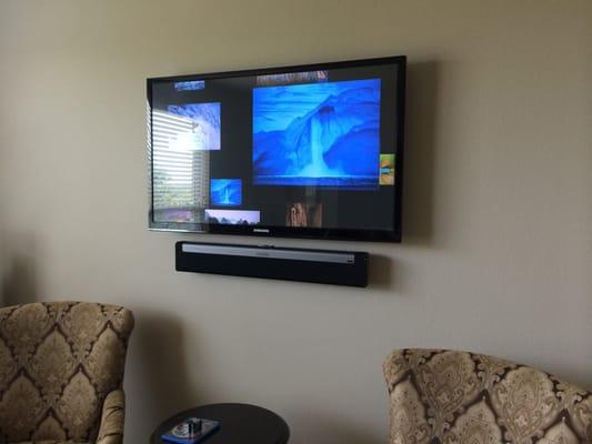 TV hang with floating sonos soundbar in master bedroom. All wiring cleanly concealed