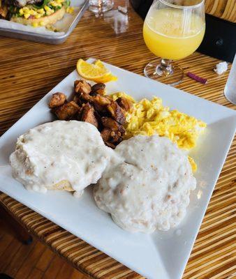 Biscuits and sausage gravy with eggs and home fries.