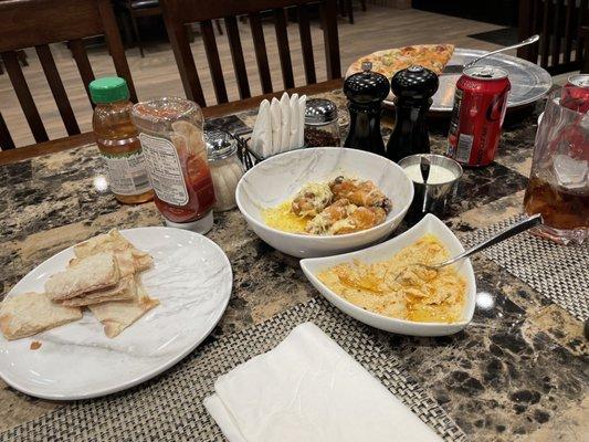 Hummus, pita bread, parmigiana garlic chicken wings and pizza.