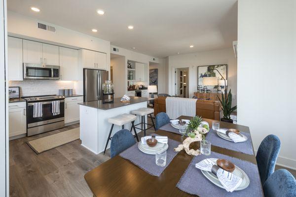 Model apartment view of dining, kitchen and living room