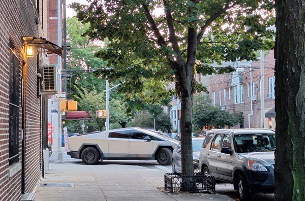 This is the 'Layers' shop's own Tesla Cybertruck, 'parked' over an entire crosswalk, endangering pedestrians and blocking visibility