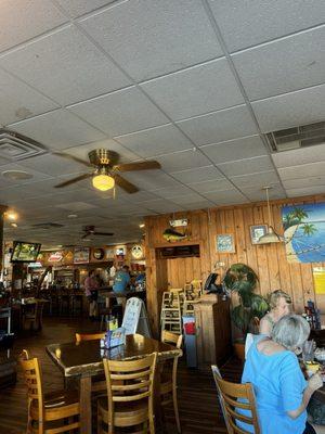 Seated by the window looking into main dining area with bar in background. Lunchtime on a weekday.