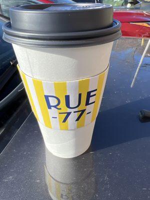 A to go coffee showing Rue 77 logo.