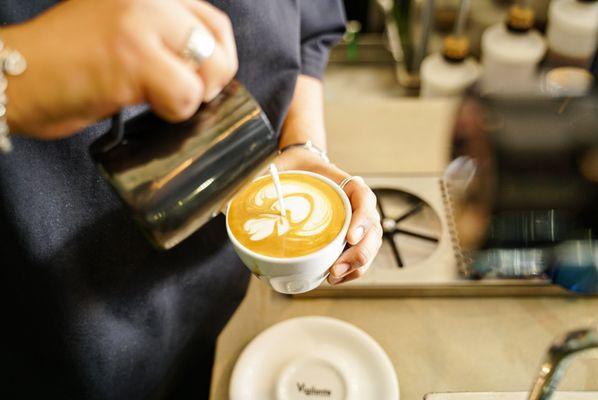 Vigilante barista crafting a latte