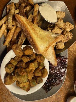 Calf fries meal with sliced brisket and two sides: French fries and fried okra.