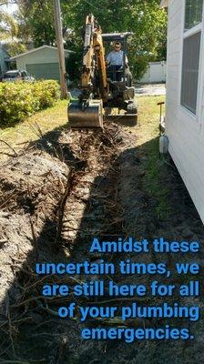 Backhoe working to fix a plumbing pipe issue near Yulee, FL.