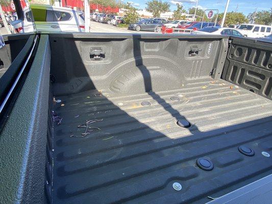 Dirty truck bed. Could have been blown out, swept out, or vacuumed