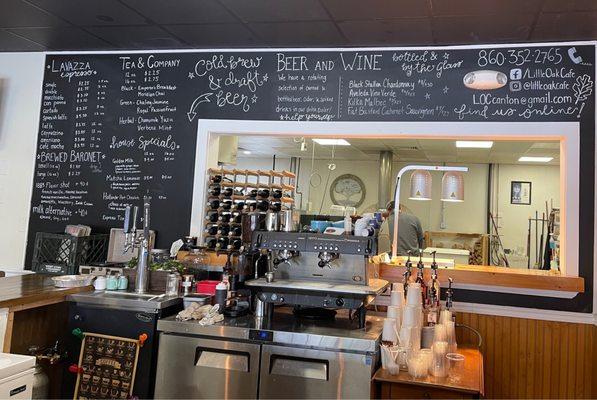 Menu and kitchen area behind small bar area