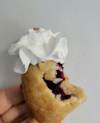 The perfect bite. Mixed berry hand pie with whipped cream