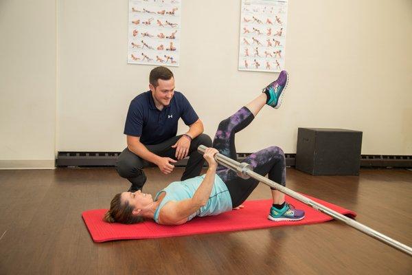 Dr. Andrew Eliszewski coaches a patient through a strengthening exercise.