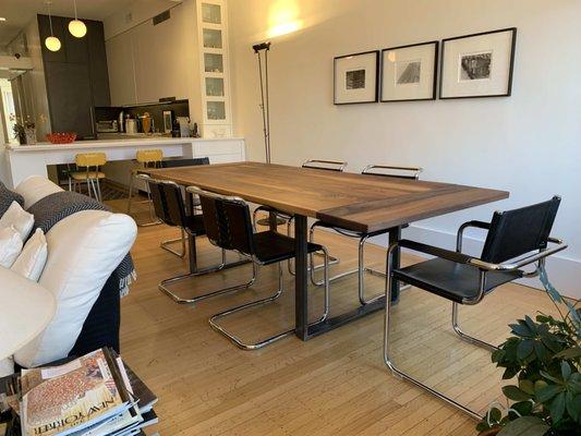 Walnut table with extender boards.