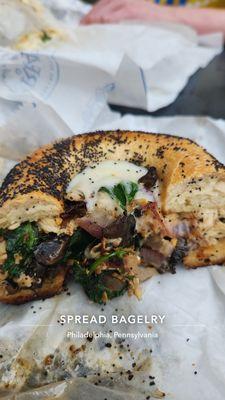 Chicken cheesesteak sandwich on a poppy seed bagel