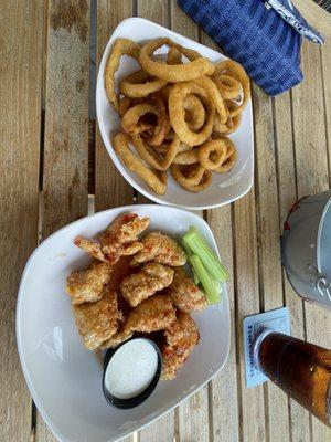 Sweet and Spicy boneless wings and a side of onion rings.