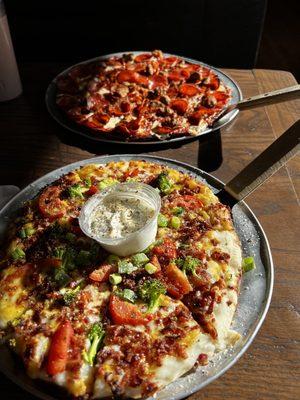 Mashed potato pizza and a meat lovers.