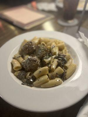 Rigatoni pasta with funghi sauce with meatballs.