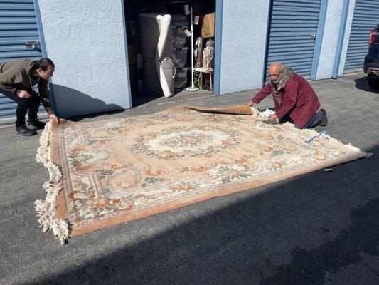 Looking at the rug before taking them