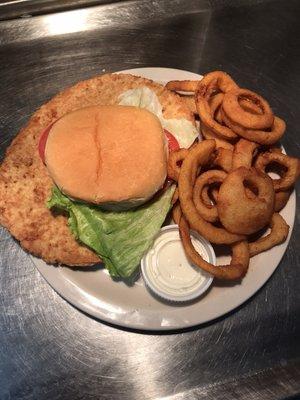 Our LARGE breaded tenderloin, served with onion rings.