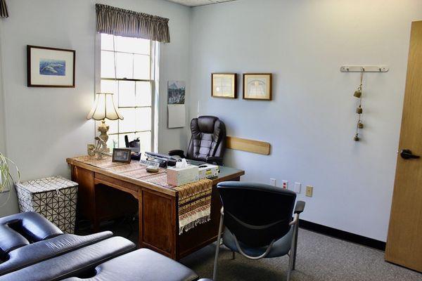 Dr.'s private office with treatment table in foreground.