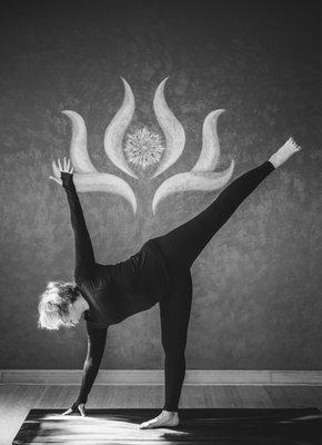 Owner practitioner in balancing half moon pose