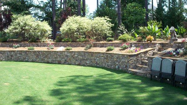 Retaining wall, landscaping with sod installation.