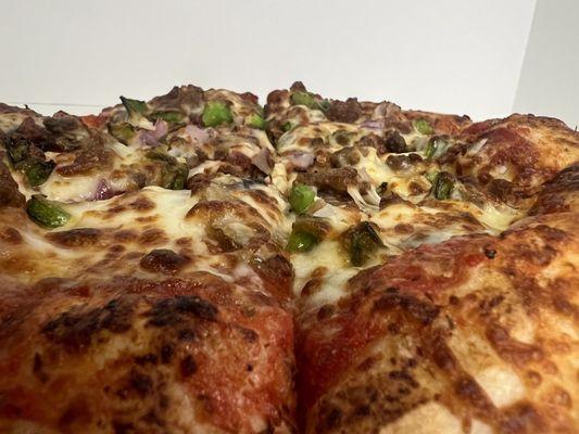 Our "Just Deluxe" Pepperoni, Ham, Mushrooms, Ground Beef, Sausage, Bacon, Onions, & Green Peppers.