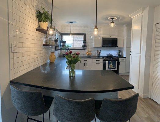 Kitchen cabinets, vinyl flooring, and subway tile. From Show Flooring