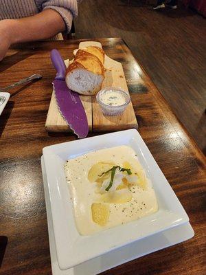 Complimentary bread with herb butter, and we ordered Alfredo sauce for dipping.